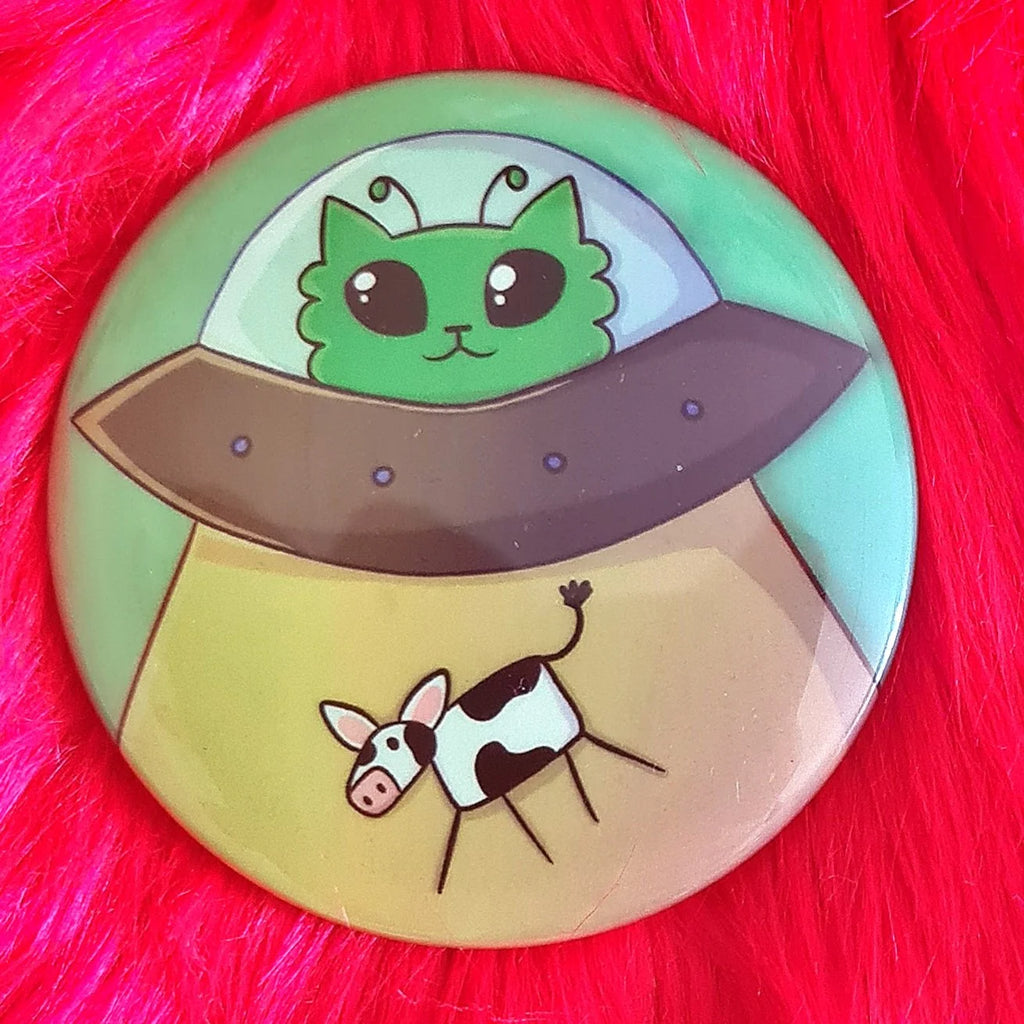 Kissat, pimeässä hohtavat pinssit